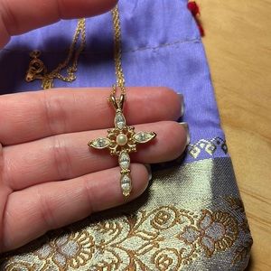 Gold necklace with a gold cross and small pearls